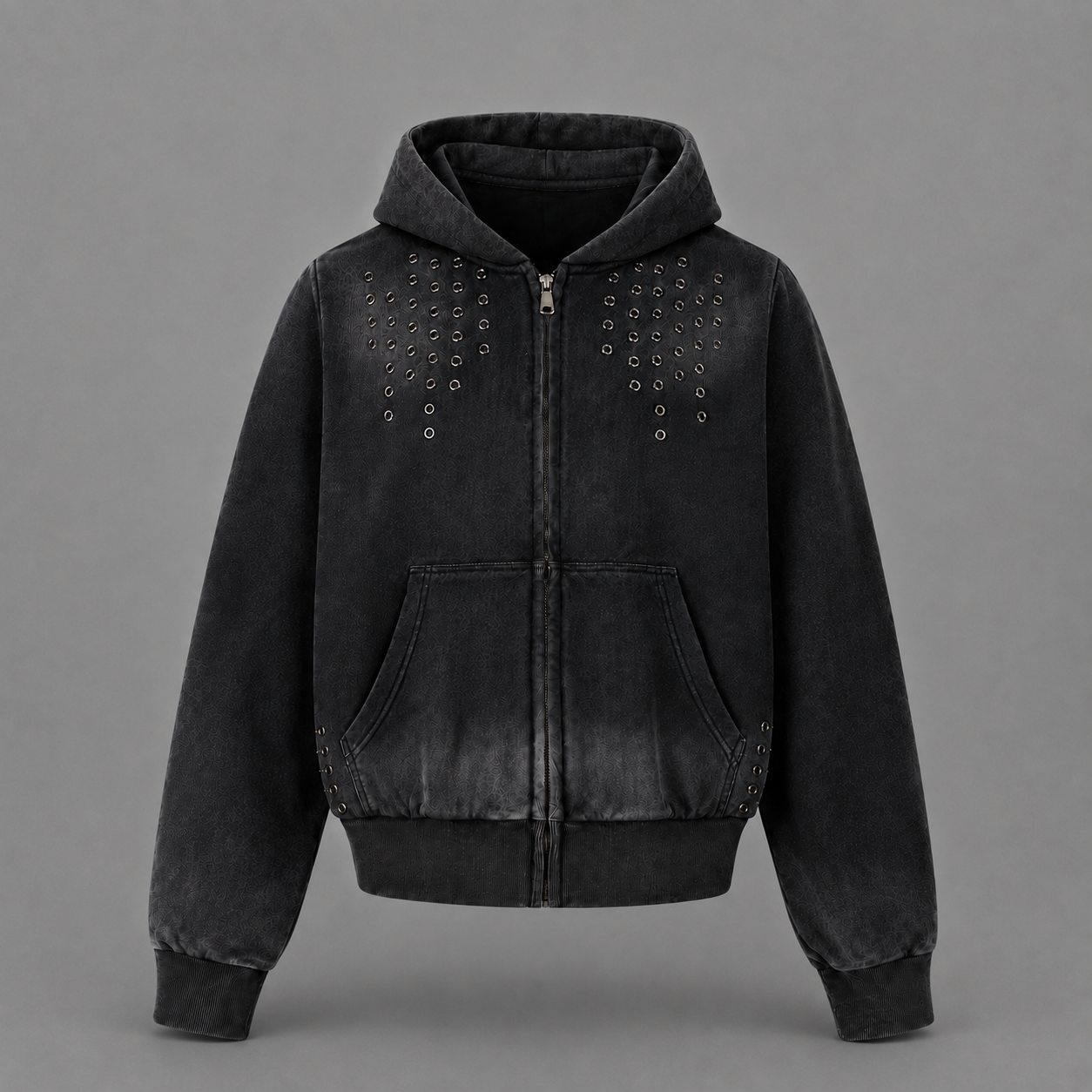 A black washed zip-up hoodie jacket with silver metal studs arranged in vertical rows on the chest, shown against a solid gray background.